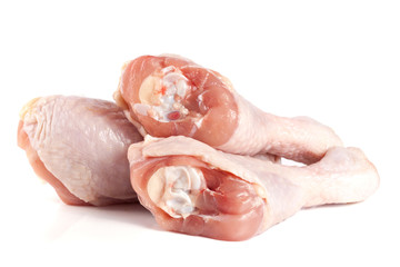 Three raw chicken drumsticks isolated on white background