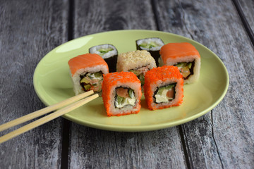 Set of rolls on the plate with chopsticks