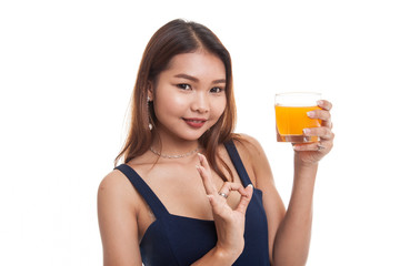 Young Asian woman show OK drink orange juice.