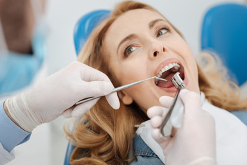 Competent skillful dentist doing some manipulations