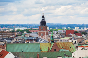 Obraz premium Beautiful high gothic town hall tower with clock in the main Market Square in Cracow, Poland. Travel Europe. Aerial view. Panorama of city