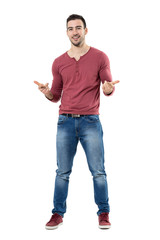 Fototapeta premium Cheerful trendy casual man smiling and pointing at camera choosing you. Full body length portrait isolated over white background. 
