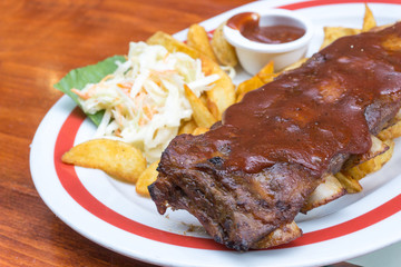 Grilled steak - Grilled meat ribs on the plate with hot sauce