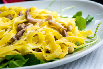 tasty pasta with roast ham on the table