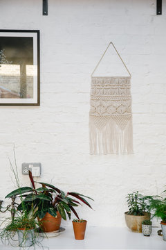 Interior with woven wall hanging with plants