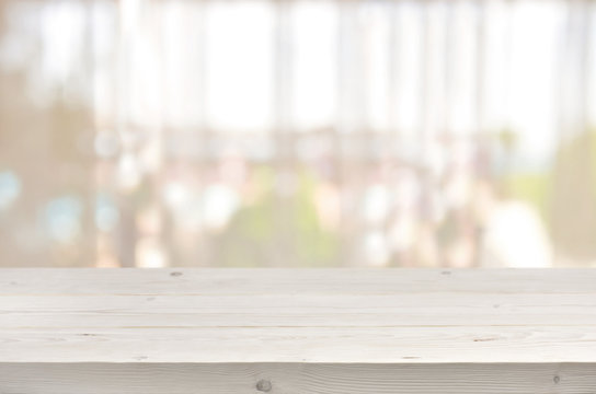 Wooden Table In Front Of Blurred Transparent Window Curtain Background