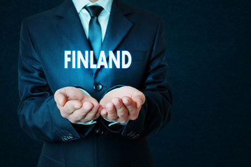 Businessman holding Finland word