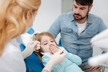 Fototapeta premium Pretty little girl afraid of the dentist