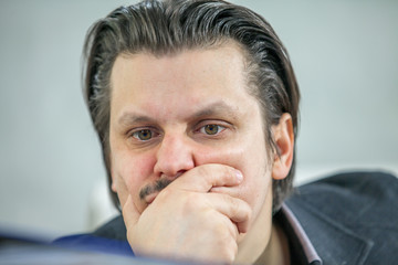 A businessman is looking worried about something.