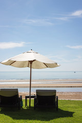 Beach chairs on the tropical beach with umbrella