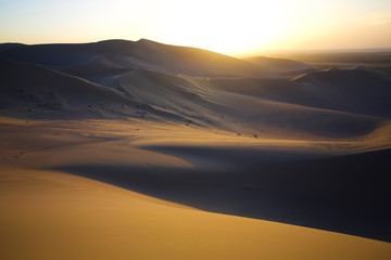 Fototapeta na wymiar Tranquil yellow sand desert , sunset scene ,Scenery in Tibet .