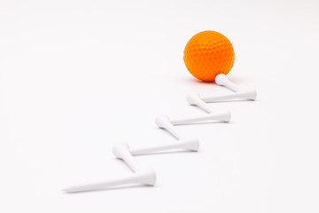 White golf balls and wooden tees