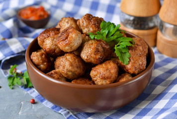Home meatballs with spices on a concrete background