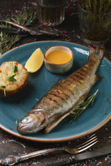 Whole grilled fish with sweet sauce and potatoes