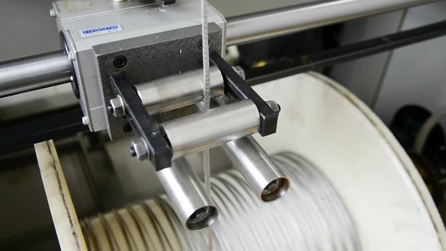 High-speed braiding machine. Winding the finished braid over the reel.