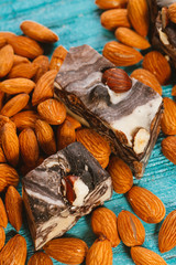 candy paste and almonds on blue wooden background