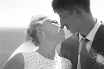 black and white photo the bride  groom on the background of fiel