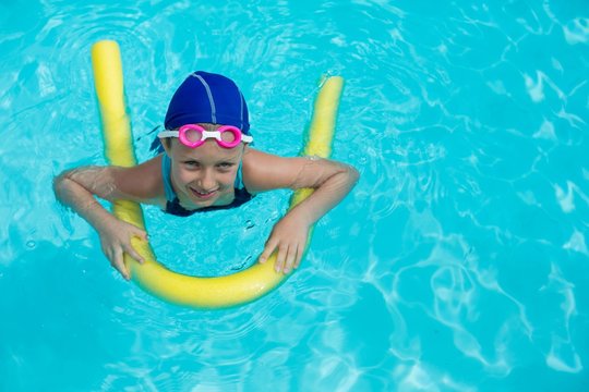 Little Girl Swimming With Pool Noodle