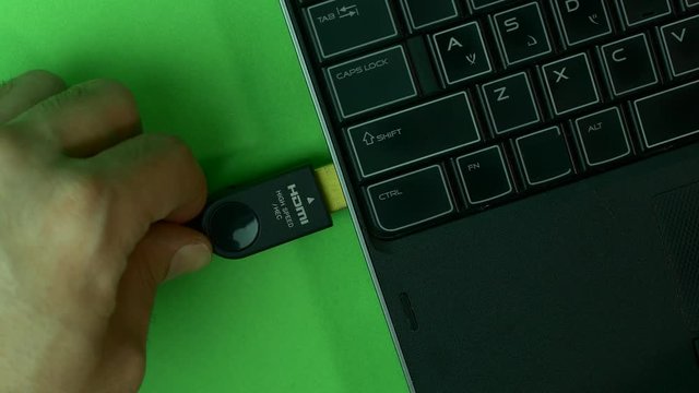 Hand Inserting HDMI Cable In Laptop, Green Screen, High Angle, Detail
