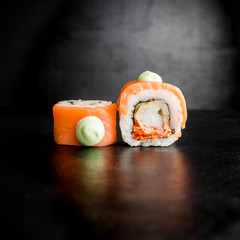 Japanese food - sushi rolls isolated on a black background. Restaurant food.