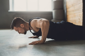 Young man fitness workout, push ups or plank