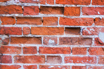 The texture of the old destroyed red brick wall. An ancient building.