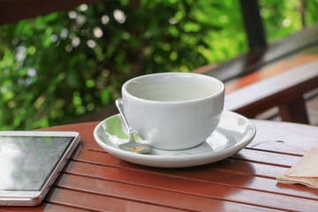 coffee cup on the wood floor background