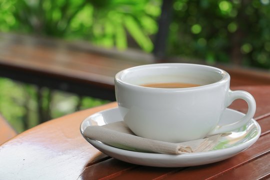 coffee  in cup  on  wood floor background