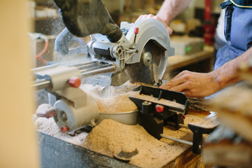 Carpenter hands working in furniture wood industry