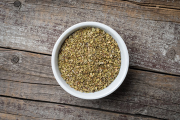 Dried marjoram in white bowl