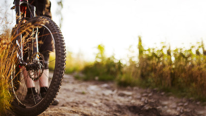 Close-up of MTB bike wheel on dirt road