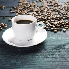 Coffee cup with grains and copyspace on dark texture