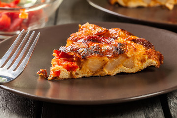 Tortilla de patatas. Spanish omelette with sausage chorizo, potatoes, paprika and egg, accompanied by olive oil