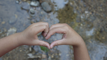 heart shape her hand's nature green background