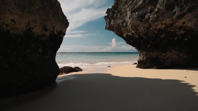 Clean white sand beach with turquoise water between cliffs - Geger beach, Bali on sunny summer day. Shot with Sony a7s on slider