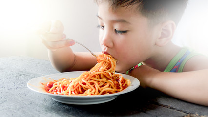Asian boy eating spaghetti - 143914530