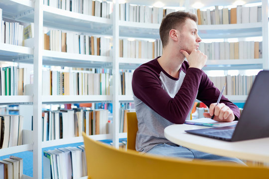 University student day-dreaming in library