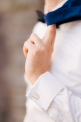 The jacket on the man is close-up. The bridegroom at the wedding.