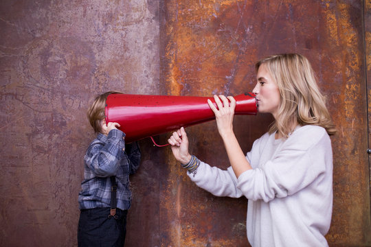 Mother talking to son by loudspeaker