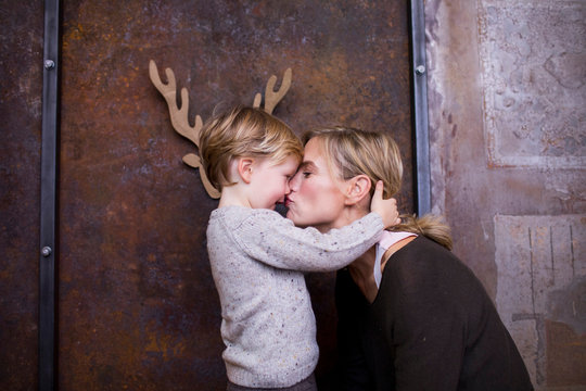 Woman kissing son