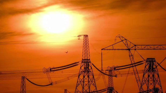 A high voltage substations, in the sunset. Transmission power lines. Timelapse. Heat haze.