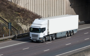 Road transport - white lorry on the motorway