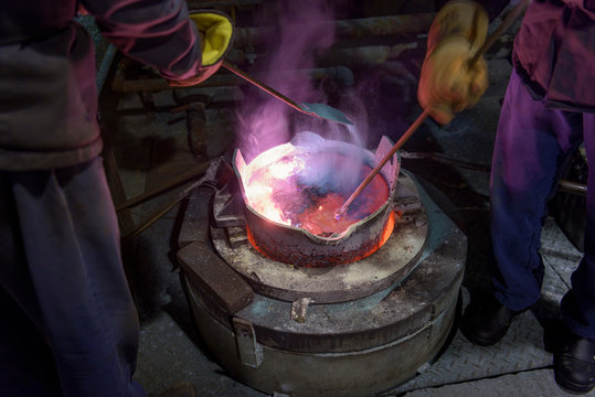 Workers Stirring Molten Aluminium Alloy In Precision Casting Factory