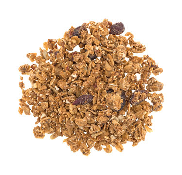 Top view of organic cranberry nut granola in a pile isolated on a white background.
