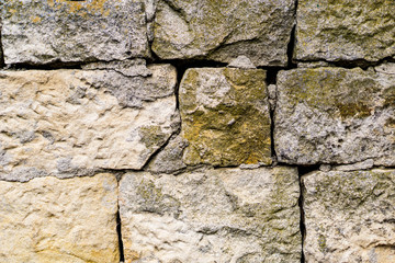 Closeup nafragment wall of chipped stone, rock walls, overgrown with moss and fungi. Vintage, Grunge, nostalgia.Black and white texture.
