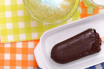 Chocolate ice cream on white plate and green ice. top view