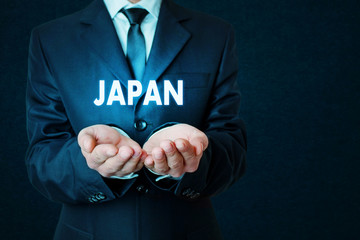 Businessman holding Japan word