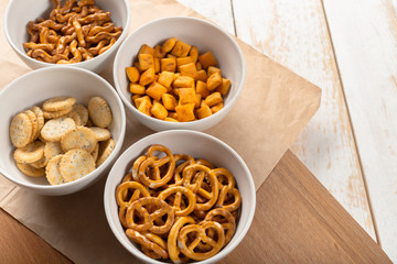 Pretzels in bowls on wooden table from above