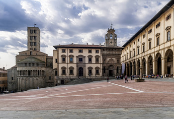 Fototapeta na wymiar Beautiful view of the Piazza Grande square in the historic center of Arezzo, Tuscany, Italy, under a dramatic sky