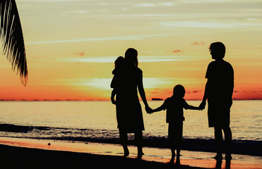 happy family with two kids on sunset beach